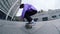 Focused skater making kickflip in slow motion. Hipster riding on longboard.