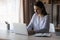 Focused smart young businesswoman working on computer at home office.