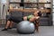 Focused sportswoman exercising with fitness ball