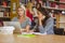 Focused students on laptop with classmates behind them