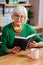 Focused stylish septuagenarian woman attentively considering the Bible lines