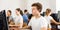 Focused teenager male student sitting at desk in computer class, preparing for exam