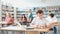 Focused teenager male student sitting at library desk, preparing for exam