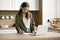 Focused teenager schoolkid girl in glasses studying from home