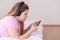 Focused teenager scrolling social networks listening to music and singing along