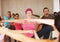 Focused on their teachers instructions. a class of smiling yoga students following their instructor during yoga lessons.