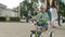 Focused toddler in amusement park. Little kid making first try on bike outside