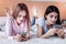 Focused two girls scrolling web pages down