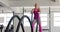 Focused unaltered caucasian woman exercising with battling ropes at gym, in slow motion