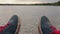Focused view of plimsolls at foreground and defocused view of river at background. Good mood.