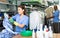 Focused woman drycleaner removing spots and stains