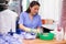 Focused woman drycleaner removing spots and stains