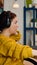 Focused woman gamer sitting on desk, putting on headset