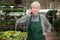 Focused woman garden shop owner having phone conversation