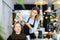 Focused woman hairdresser cutting hair of elderly female client