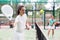 Focused woman and man learning to play padel on court