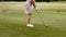 Focused woman playing golf