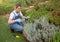 Focused woman pruning flower