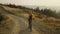 Focused woman riding sport bicycle on road. Cyclist exercising in mountains