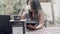 Focused woman sitting at table in outdoor cafe with tablet