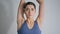 Focused woman training alone at white home closeup. Sport girl stretching hands