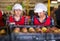 Focused woman working on fruit sorting line at warehouse