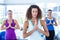 Focused women in fitness studio with hands joined