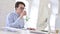 Focused Working Young Man Drinking Coffee and using Desktop