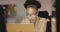 Focused young African American woman works diligently on her business laptop in an office setting