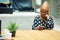 Focused young islamic African woman using smartphone while sitting at cafe