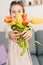 focusing camera on a bouquet of flowers in the hands of a little girl