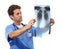 Focusing on finding a treatment. Studio shot of a handsome young doctor examining an x-ray he is holding up.