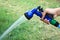 Focussed on the hand of a woman using a water spray