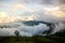 Fog and cloud mountain valley spring landscape.Forested mountain slope in low lying cloud