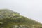 Fog, clouds, rocks and cliffs on VeslehÃ¸dn Veslehorn mountain, Norway