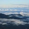 Fog and clouds surrounding green hills and mountains in Entlebuch, Lucerne Canton