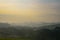 Fog covers the green hills of a tea plantation at dawn, in Kibale, Uganda, Africa