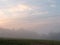 Fog at dawn over a field of farmland