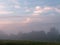 Fog at dawn over a field of farmland