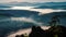 Fog flowing over river, forest in mountains in morning