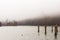 Fog on lake Kenigsee, Germany. Small island in the middle of the lake. Mist on lakeshore. German landscape.