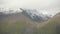 fog mass rolling over Tibet barren mountaintop,snow cover mountain.