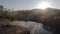 Fog morning over the plain and river floodplain of the meadow near a rural village with a house, aerial view landscape