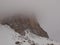 Fog in the mountains. Morning fog covers the rocks in the Italian Dolomites