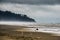 Fog Moving In To A Stormy Coastal Sand Beach With The Hills Darken By The Moving Thick Cloud in Long Beach Washington