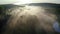 Fog over the river with rays of sunrise, aerial view