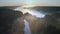 Fog over the river with sunrays at sunrise, aerial view