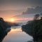 fog rises in the rays of golden light as the sun sets behind the river.