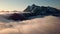 Fog Rolling Around Snowy Mountains during Sunrise in Northern Washington State