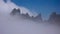 Fog rolling over a jagged mountain ridge in Switzerland